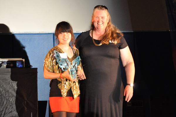Lora ChauDavis claims the Janet Holmgren Student-Athlete Service award from Sara Nevin.